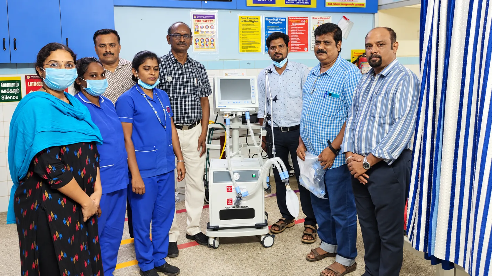 Hospital staff with critical care equipment at a handover